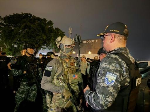 Ecuadoran Interior Minister John Reimberg greets a US Army member next to Ecuadoran police officers during a raid to dismantle a local branch of the Mexican cartel Jalisco Nueva Generación (CJNG) — Handout / AFP