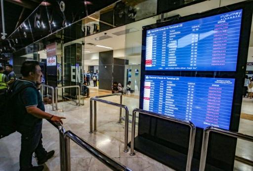 Un voyageur à l'aéroport Soekarno-Hatta de Tangerang après l'éruption du volcan Anak Krakatoa consulte le tableau des départs pour connaître le statut des vols, le 6 septembre 2026 en Indonésie — Syarief Akbar / AFP