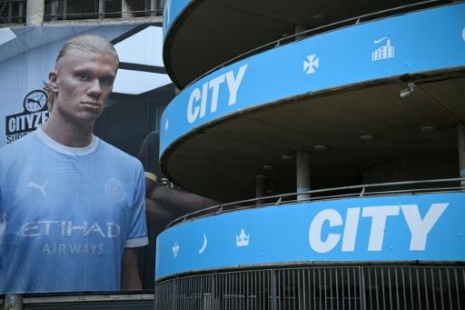 A poster of Manchester City striker Erling Haaland is pictured outside The Etihad Stadium — Oli SCARFF / AFP