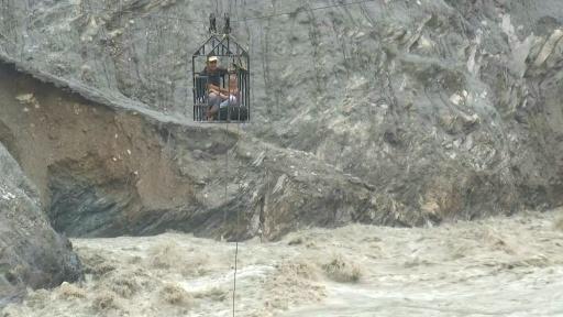 Nepal flood survivors cling to zipline across treacherous river