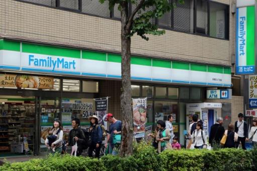 FamilyMart started to relax dress codes this year in an attempt to lure workers, including young people who want to maintain their own style — YOSHIKAZU TSUNO / AFP