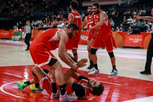 Iran's players celebrate winning the men's basketball bronze medal — DAVID GRAY / AFP