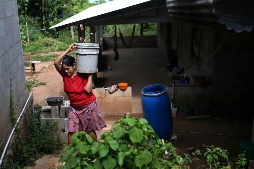 Vilma Ortiz, de 53 años, lleva un balde de agua para regar sus cultivos en el departamento de Morazán, El Salvador, el 10 de septiembre de 2026. — Marvin RECINOS / AFP
