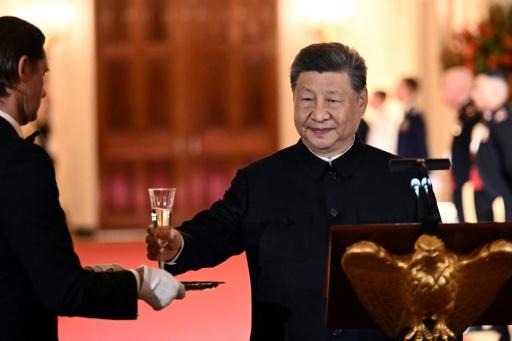 China's President Xi Jinping takes a glass to propose a toast during the State Dinner — Brendan SMIALOWSKI / AFP
