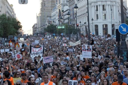 Demonstrators rattled keys and blew whistles as they made their way through central Madrid — Oscar DEL POZO / AFP
