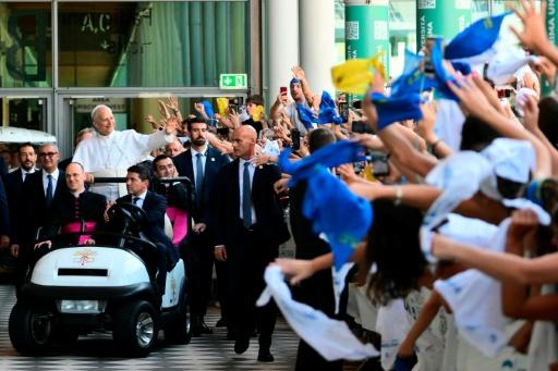 Pope Leo XIV greets the crowd as he arrives for a visit at the Children's village of the Meeting for Friendship among Peoples, the traditional gathering organised by Communion and Liberation, during a pastoral visit in Rimini on August 22, 2026. — Stefano RELLANDINI / AFP