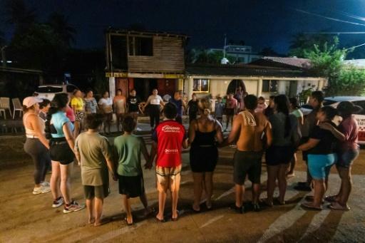 Residents pray as Hurricane Polo passes Playa Azul beach in the municipality of Lazaro Cardenas, Michoacan, Mexico — Enrique Castro / AFP