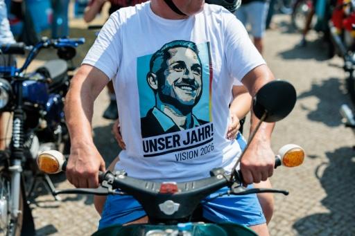 An AfD supporter wears a T-shirt with an image of Ulrich Siegmund and the logo 'Our Year!' — Jens SCHLÜTER / AFP