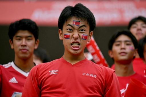 Fans with North Korean flags painted on their faces — MOHD RASFAN / AFP