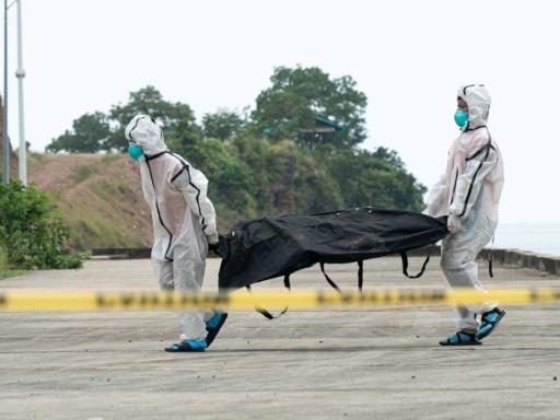Forensic investigators are working to identify the bodies, with some charred badly enough that DNA must be extracted from teeth and bones — Ron Lopez / AFP