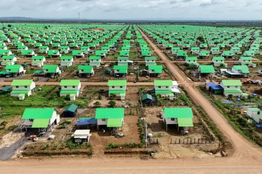 The white stilted houses with their cheerful green zinc roofs are surrounded by a small patch of land to grow vegetables — Suy SE / AFP
