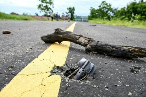 An unexploded 80mm mortar on a road in Cambodia's Chouk Chey village, months after deadly border clashes with Thailand — TANG CHHIN Sothy / AFP
