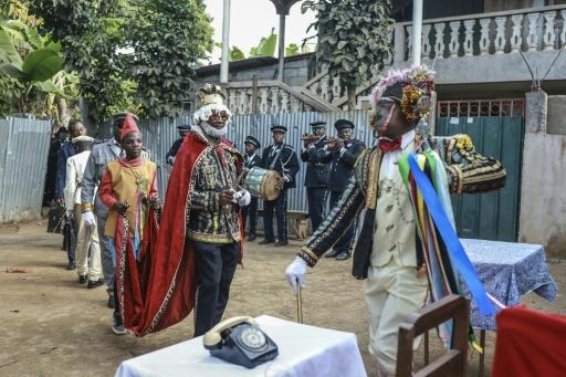 Many of the actors sport flamboyant costumes accessorised with wigs and other accoutrements — Daniel BELOUMOU OLOMO / AFP