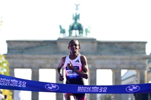 Ethiopia's Tigst Assefa crosses the finish line to win the Berlin Marathon — John MACDOUGALL / AFP