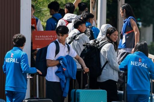 Members of Nepal's delegation arrive at the accommodation for the Asian Games — DAVID GRAY / AFP