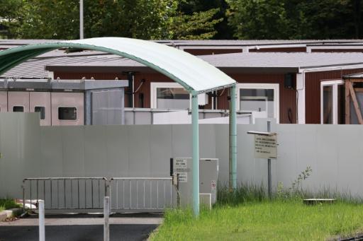Temporary wooden container huts being used to house athletes for the 2026 Asian Games — DAVID GRAY / AFP