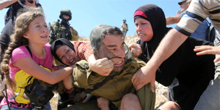 AFP photographer Abbas Momani wins the spot news prize at the Atlanta Photojournalism Seminar Contest for his image of an Israeli soldier attacked by Palestinians after he tried to arrest a boy during clashes.