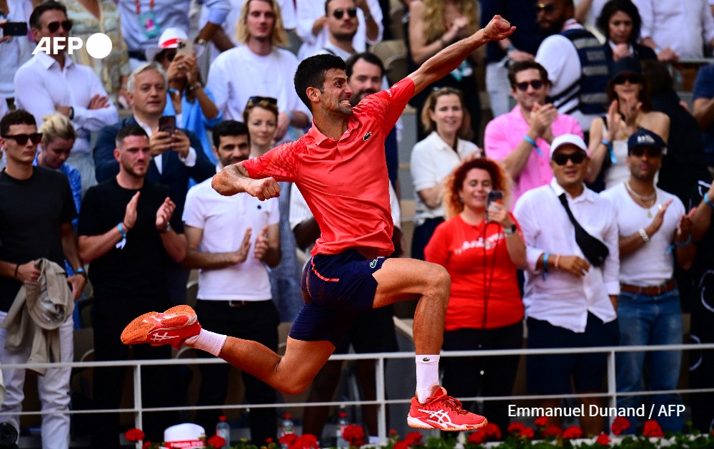 Serbia's Novak Djokovic jumps as he celebrates his victory